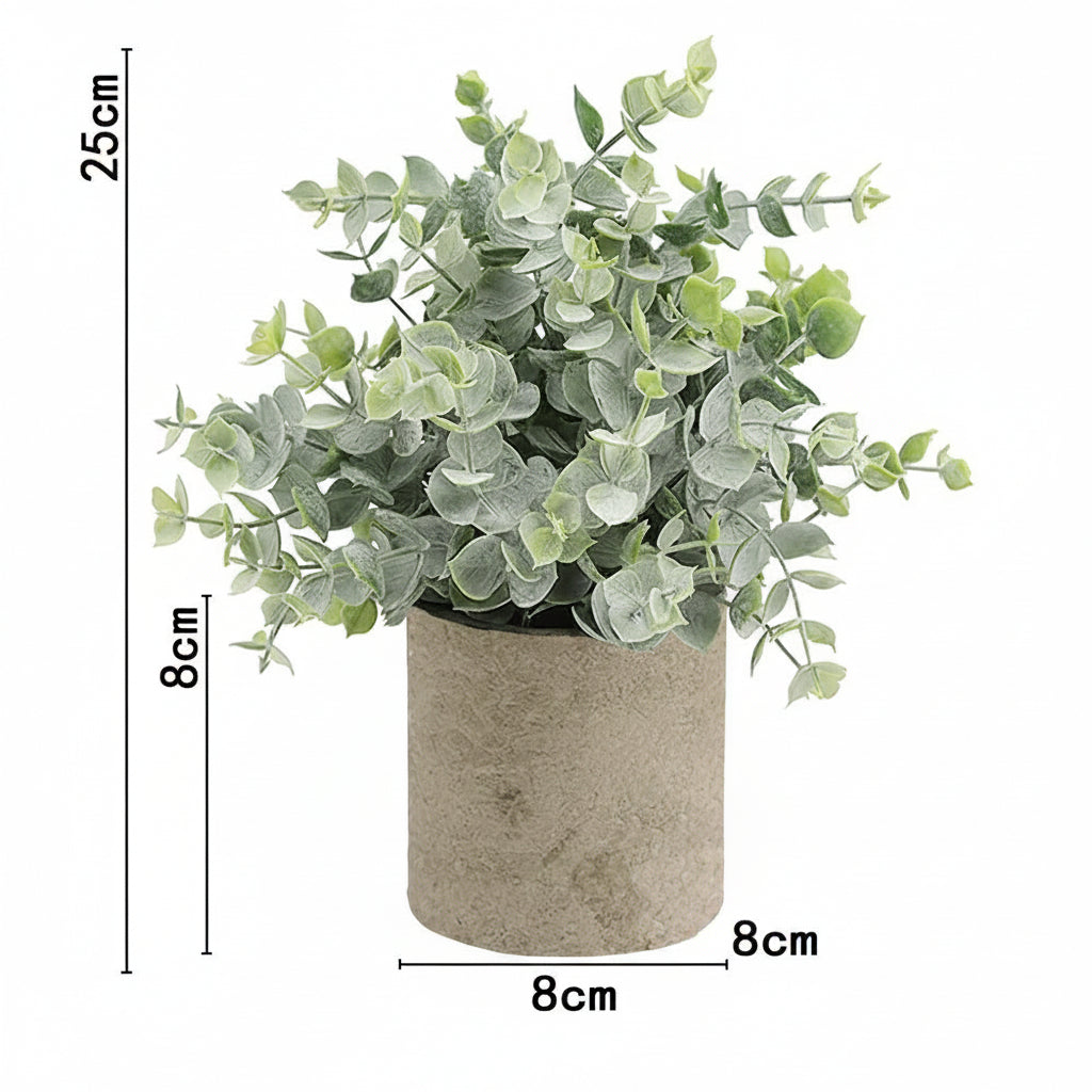 Kunstig grønn plante i dekorativ potte