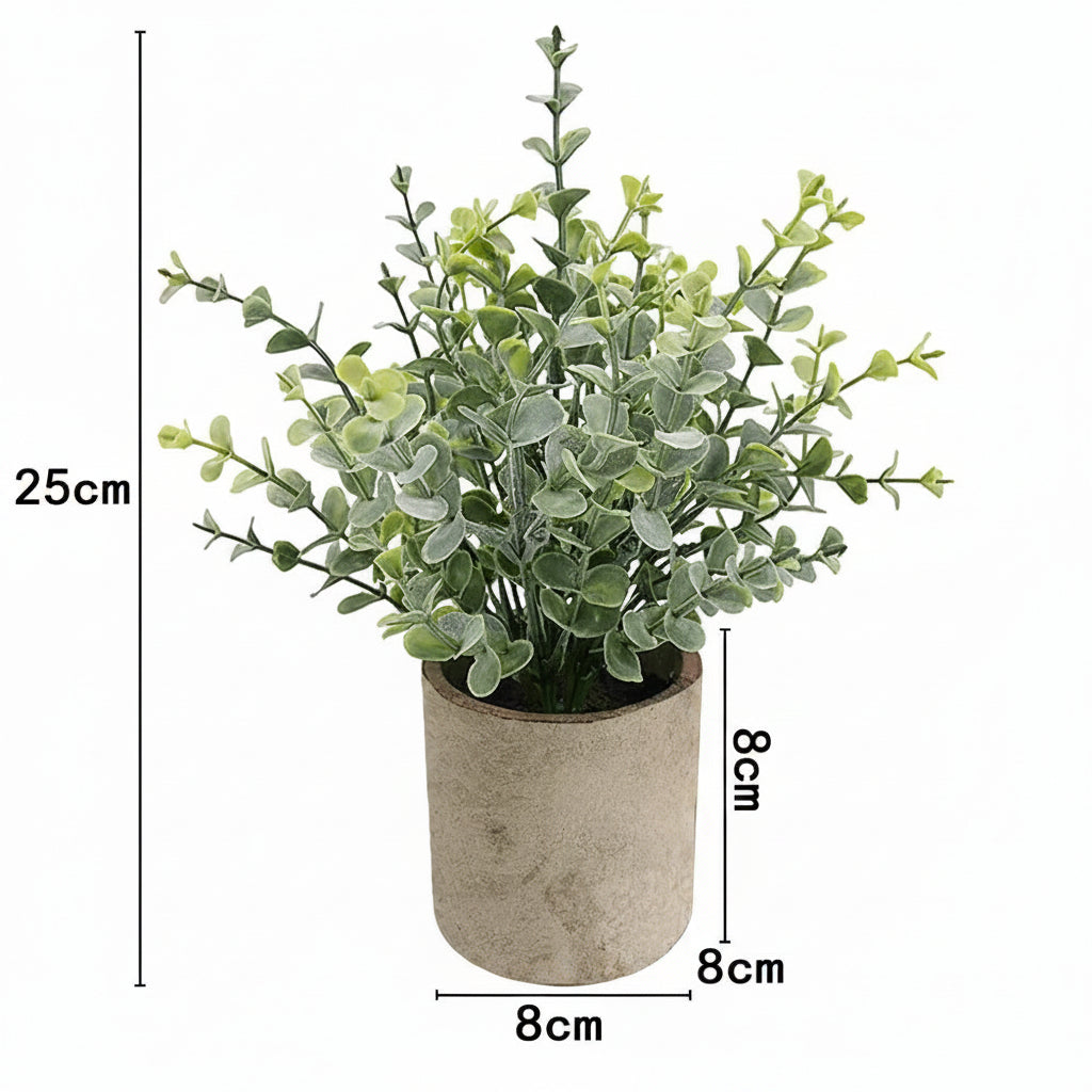 Kunstig grønn plante i dekorativ potte