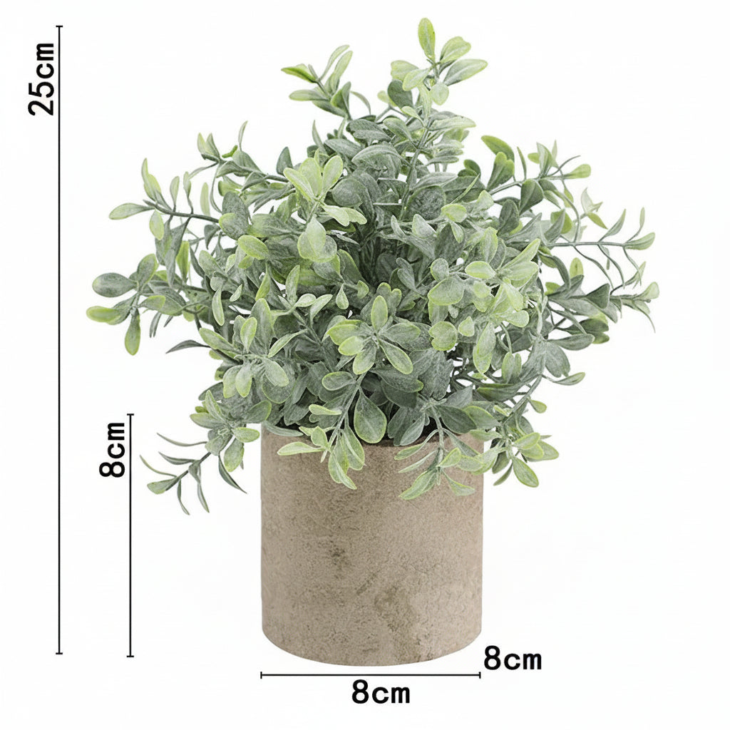 Kunstig grønn plante i dekorativ potte