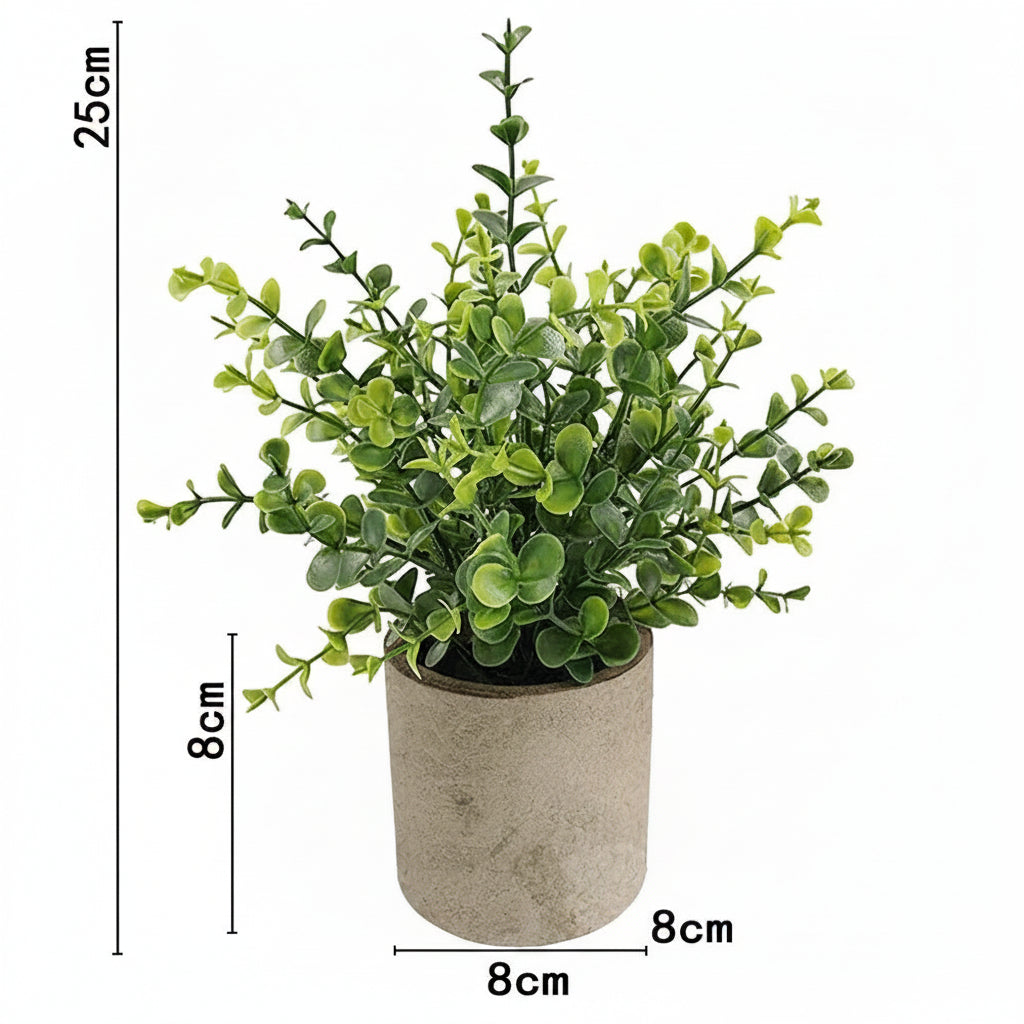 Kunstig grønn plante i dekorativ potte