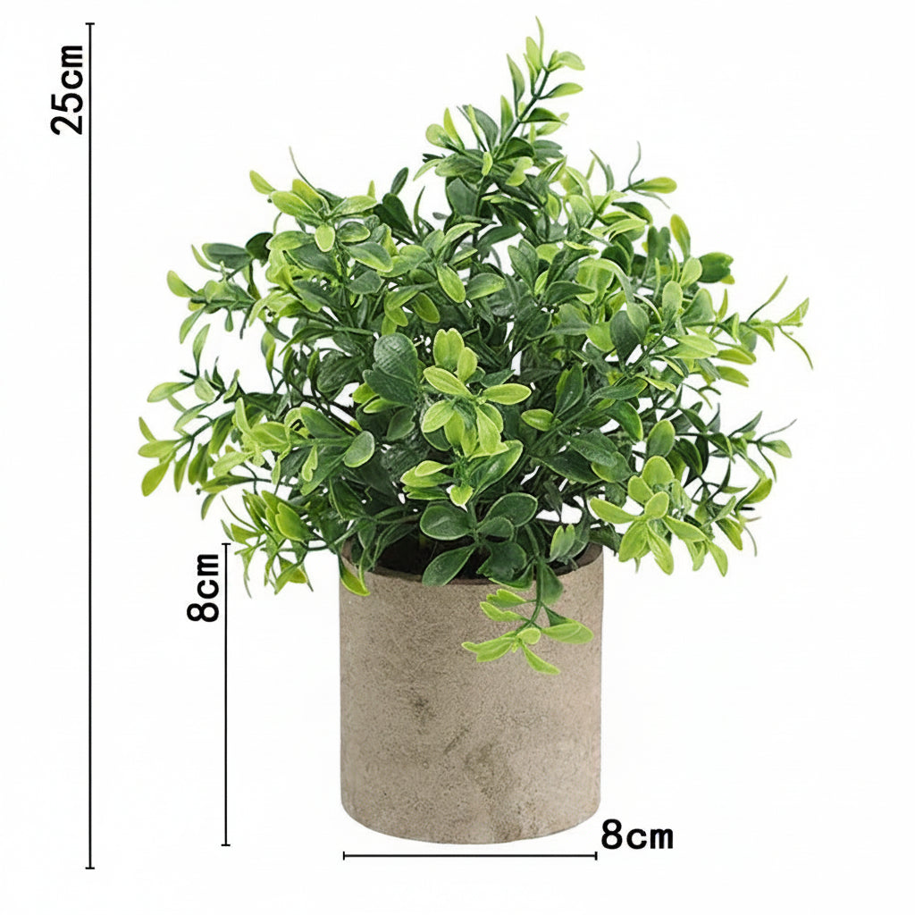 Kunstig grønn plante i dekorativ potte