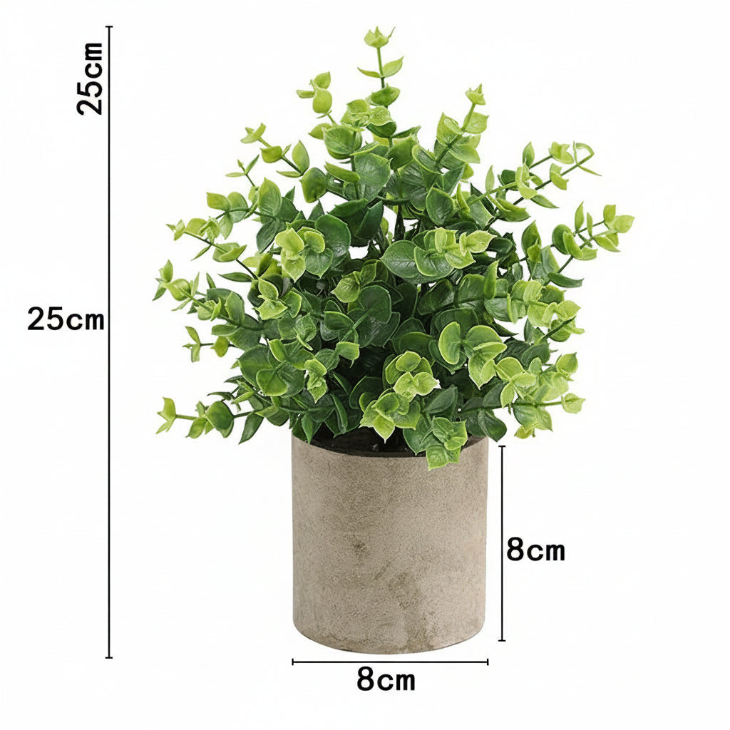 Kunstig grønn plante i dekorativ potte