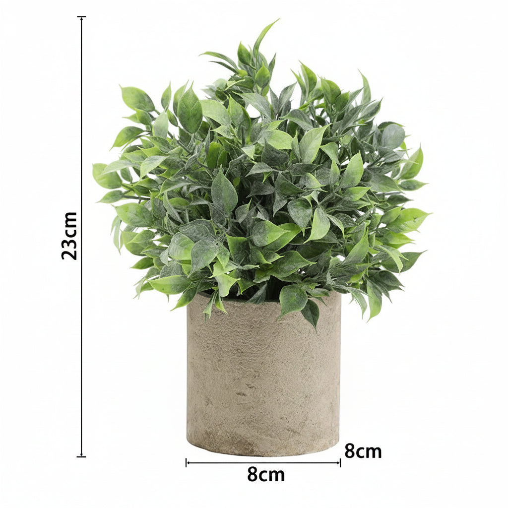 Kunstig grønn plante i dekorativ potte